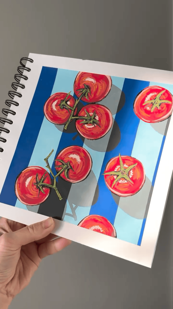 Finished marker illustration of bright red tomatoes on a blue striped background held in a sketchbook.