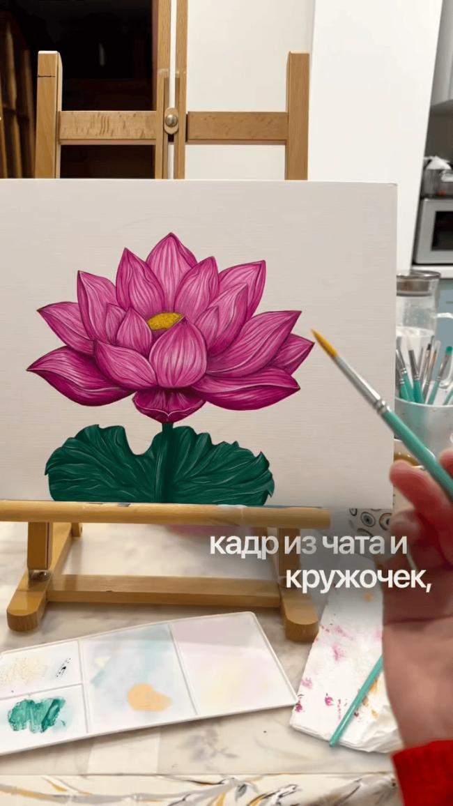 Unfinished lotus flower painting on a peach background with gold halo, shown together with two smaller artworks on a table.